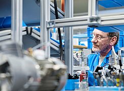 Our Quality Promise Photo of a KNF assembly working inspecting diaphragm pumps.